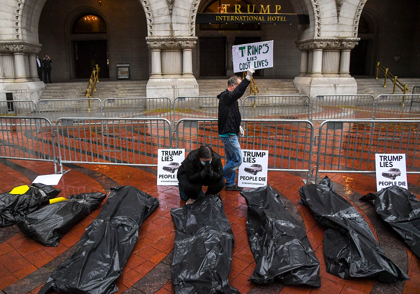 不满政府疫情应对,美抗议民众在特朗普酒店前摆放尸袋
